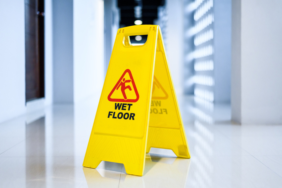 Sign showing warning of wet floor on wet floor